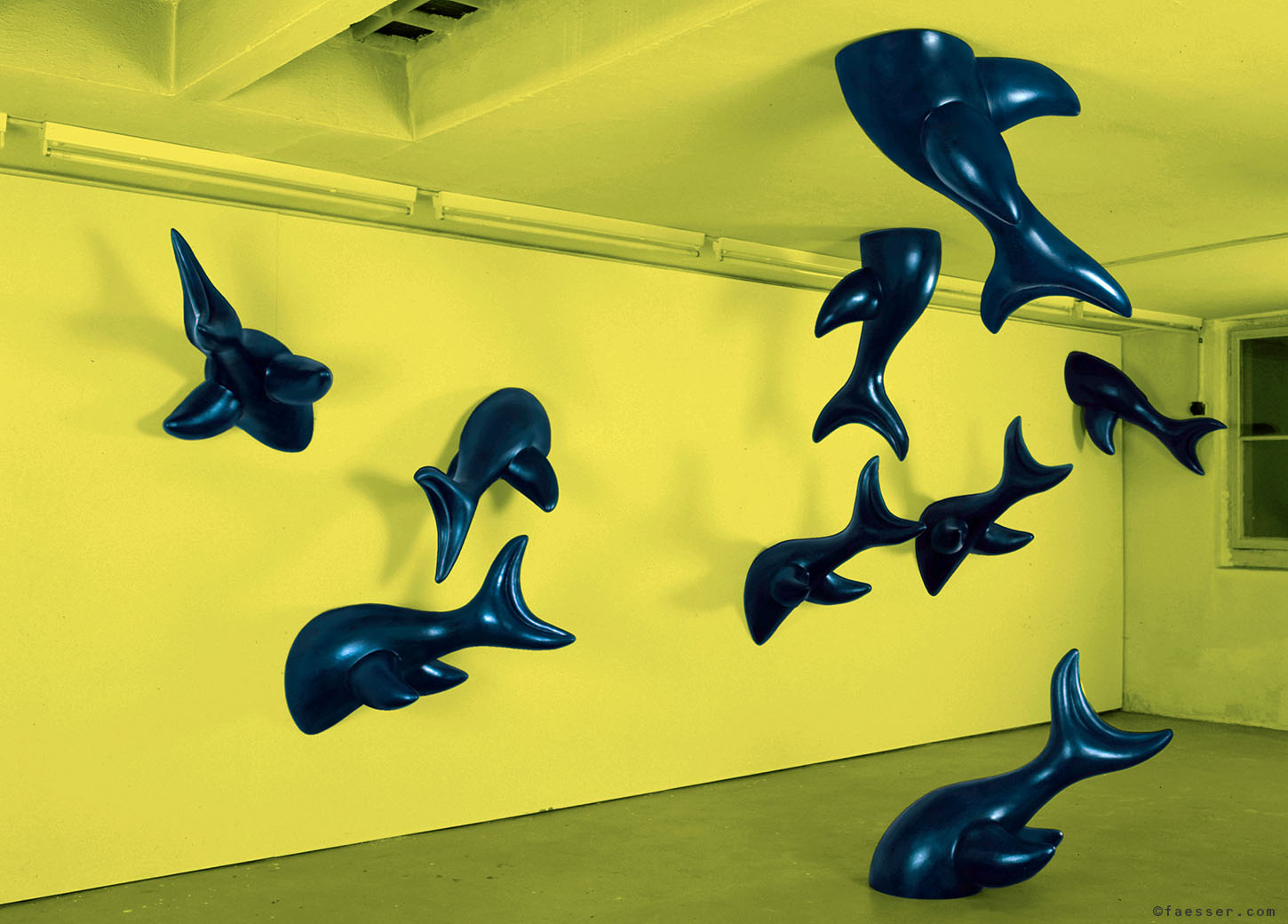 Nine out of twelve dolphins jump through the studio wall; work of art; artist Roland Faesser, sculptor and painter 1999